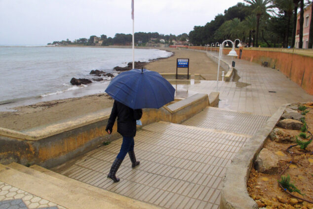 Imagen: Persona paseando bajo la lluvia en el paseo de la Marineta Cassiana de Dénia (archivo)